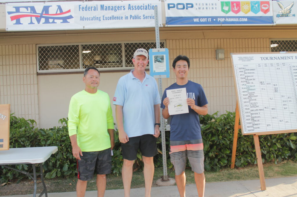 CAPT Richard A Jones, USN, former Pearl Harbor Naval Shipyard and Intermediate Maintenance Facility Commanding Officer poses with the Tournament Winner. 